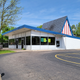 View of Chip's building from the parking lot, a small midcentury modern building